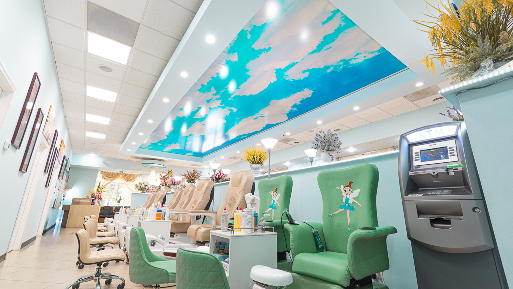 Kids' pedicure chairs with fairy designs under the blue-sky ceiling