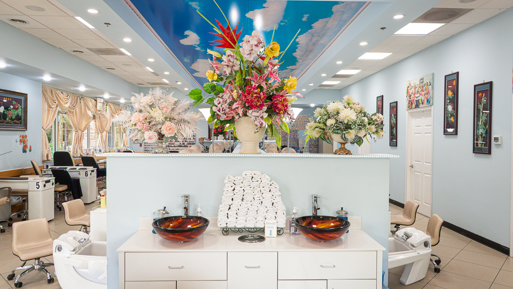 Front desk with floral arrangements and glass sink bowls